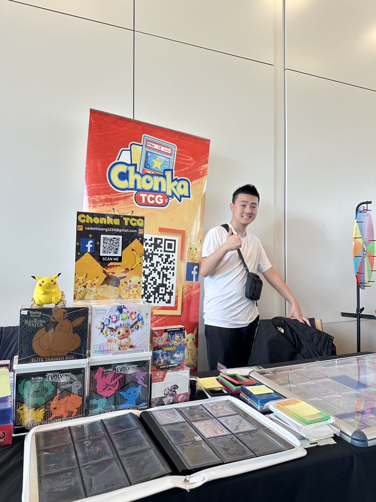 Chonka TCG vendor booth with Pokémon Elite Trainer Boxes, binders, and a Chonka TCG banner